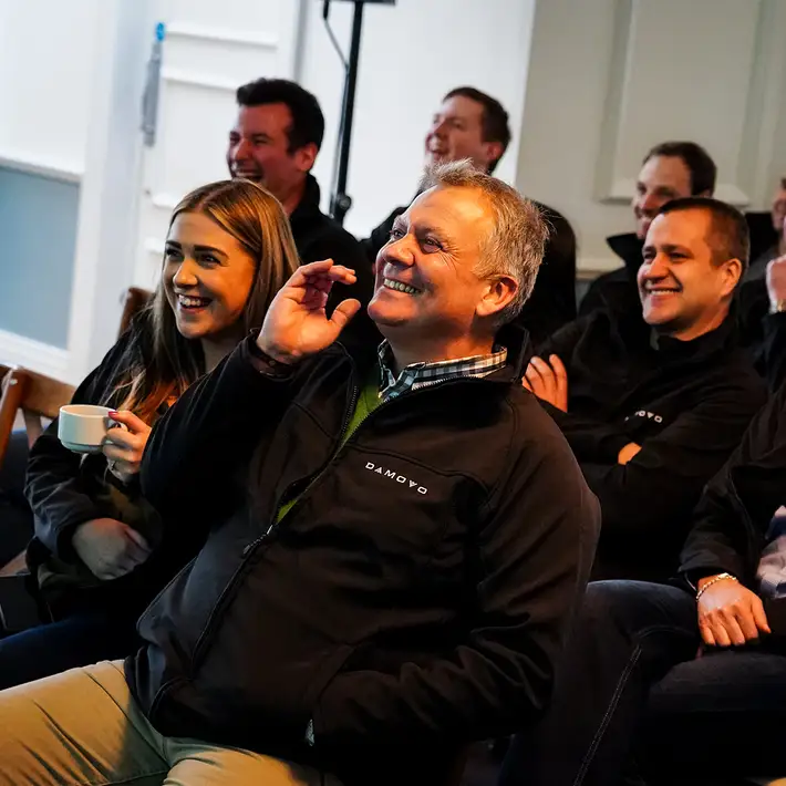 Team laughing during the showback of a Digital Treasure Hunt in Ireland.