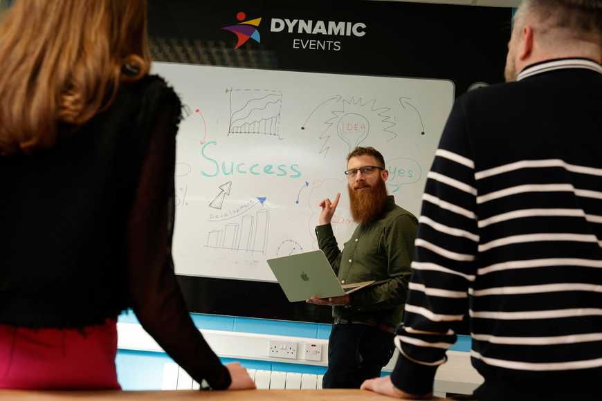 Corporate team training workshop in Ireland with facilitator leading employees through problem solving and development strategies
