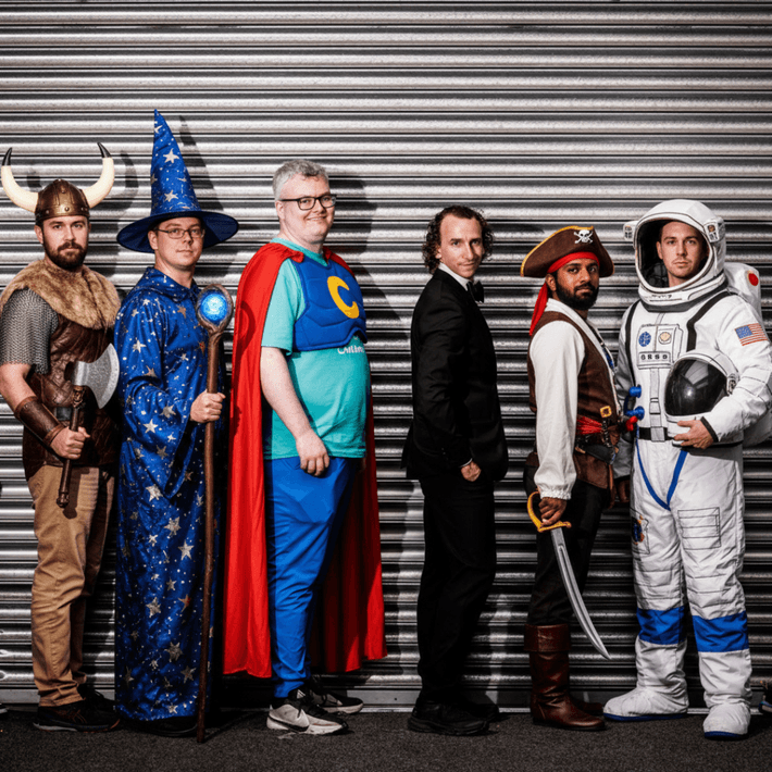 Colleagues posing for a Halloween-themed team photo during the hunt.