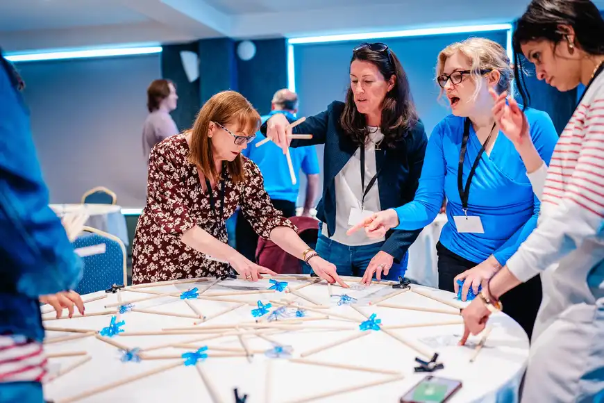 Colleagues collaborating during a team development workshop in Ireland