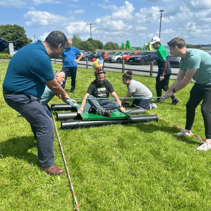  A candid shot of participants laughing mid-activity during the summer corporate event.