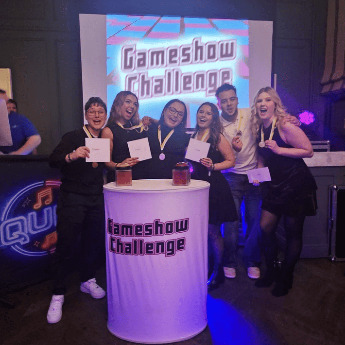 Team celebrating their win at the gameshow challenge at their Christmas corporate party