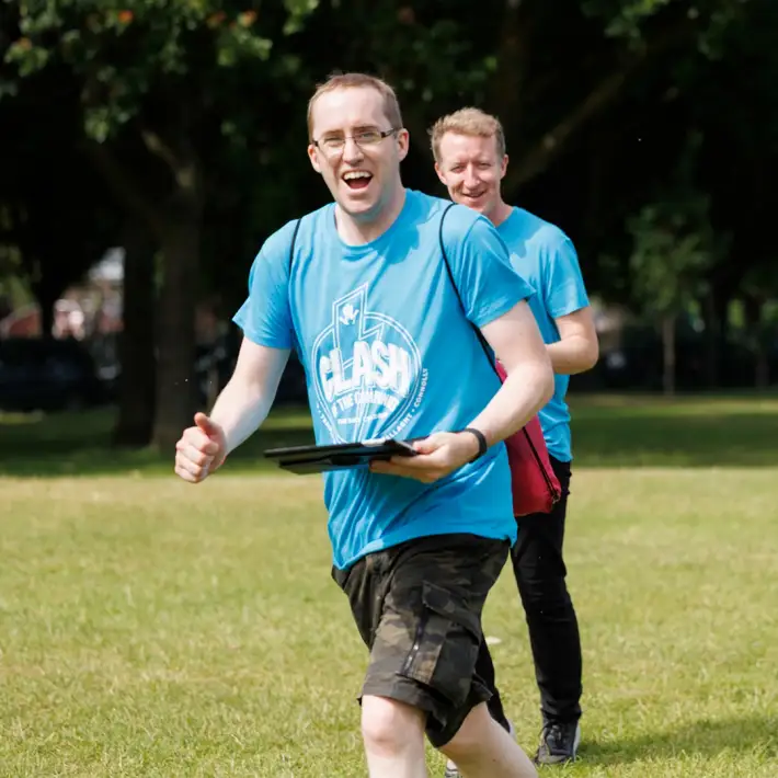 Participants running and laughing during the Space Survival team building activity, a fun outdoor GPS challenge for companies in Ireland by Dynamic Events.