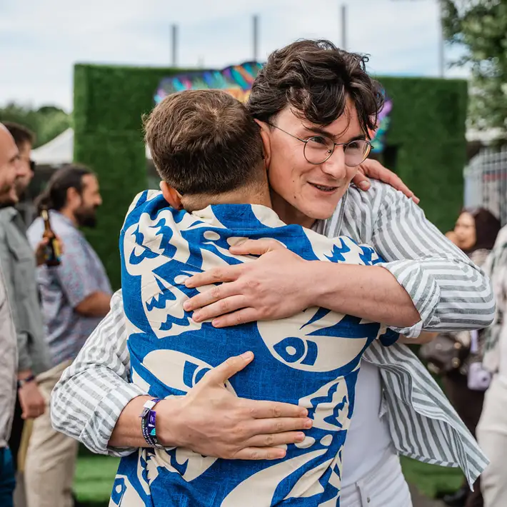 Guests hugging after arriving to the corporate event