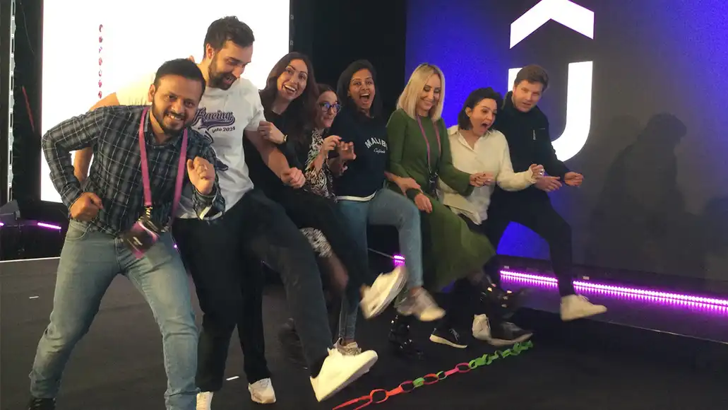 Participants crossing the finish line together during the Detour team challenge event.