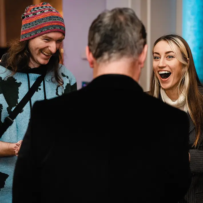 Corporate team building magic workshop in Ireland with participants reacting to a live magic demonstration