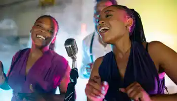 Team singing together on stage during corporate karaoke night in Ireland