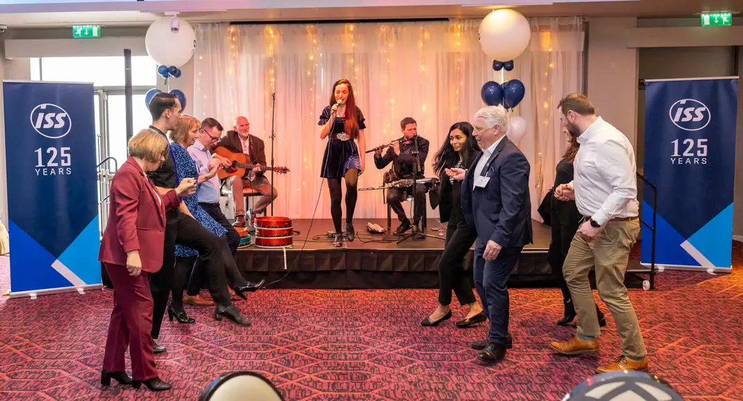 Conference attendees dancing during the ISS 125-year corporate event