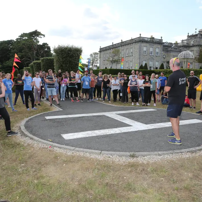 group standing beside heli pad