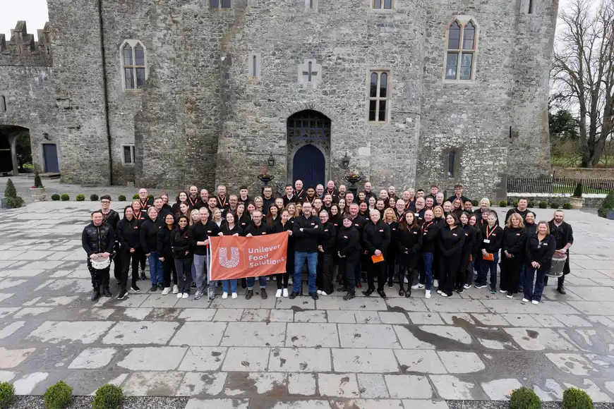 Team photo at historic Cork venue during corporate event