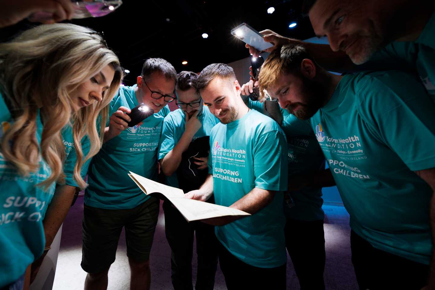Corporate team building activity in Ireland with colleagues collaborating during a challenge at an indoor event