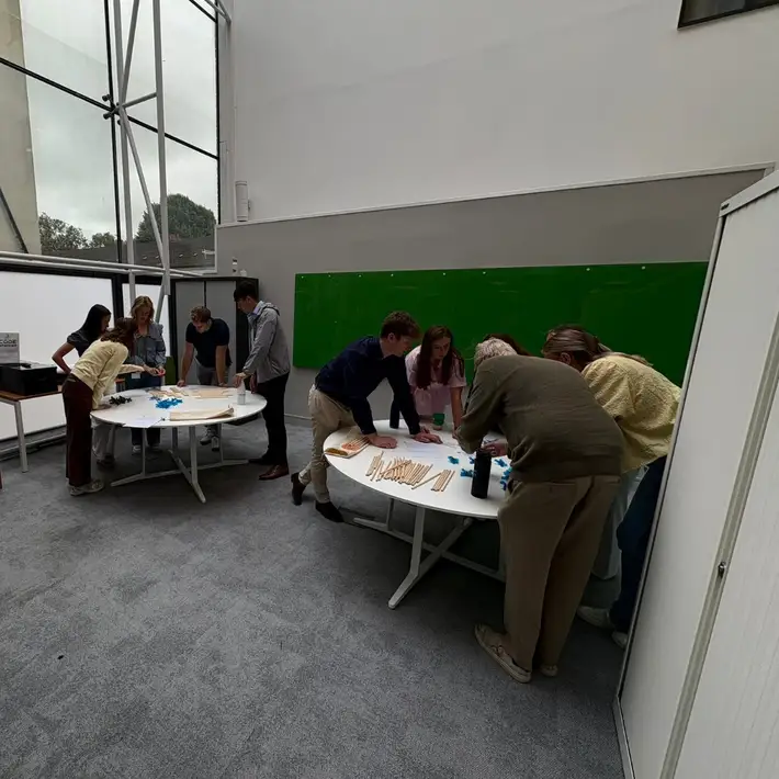 Graduates gathered in two sepeerate cicrles actively participating in the code breaker challnge focused on collaboration