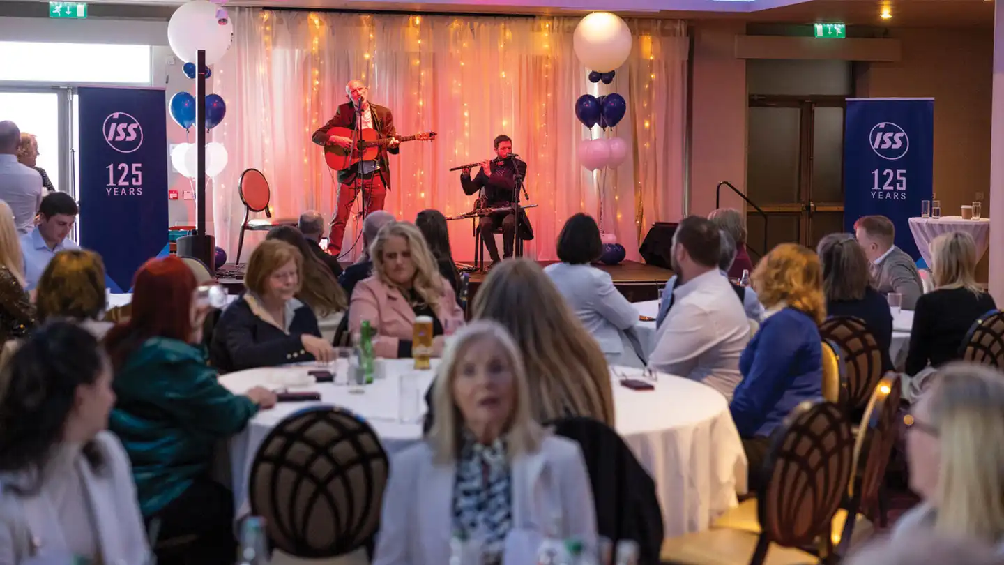 Irish music workshop corporate event Dublin with live band and audience participation at ISS 125 year celebration