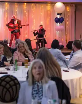 Irish music workshop corporate event Dublin with live band and audience participation at ISS 125 year celebration