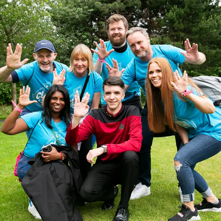 Office team enjoying a sci-fi themed outdoor team building challenge in Ireland, dressed in matching shirts and space costumes as part of Dynamic Events’ Space Survival activity.