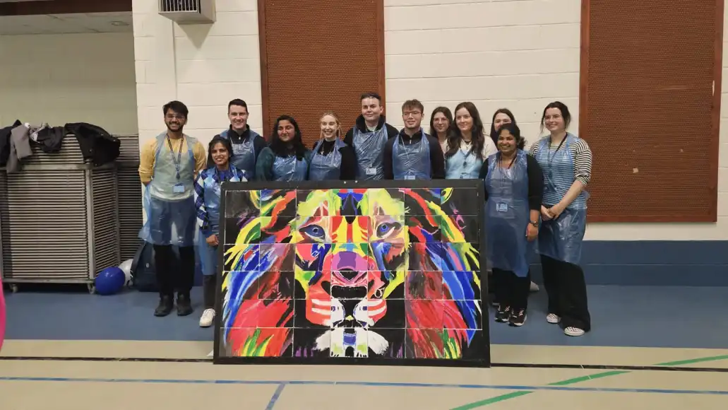 small team with their big picture team building mural