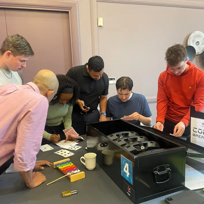 Sisk graduates working together during a Dynamic Events Code Breaker team building activity