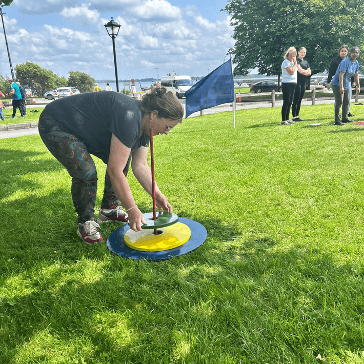 Jazz Pharma staff working together to complete a hands-on challenge outdoors during the company summer event.