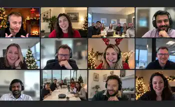 Corporate team enjoying a hybrid virtual Christmas party with festive decorations