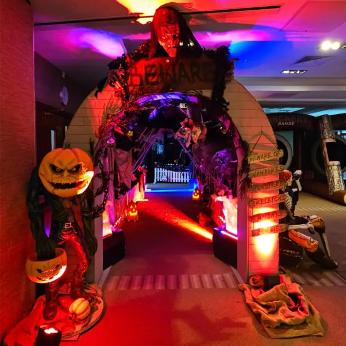 Halloween corporate family day entrance with pumpkin decorations, spooky archway, and themed lighting in Ireland.