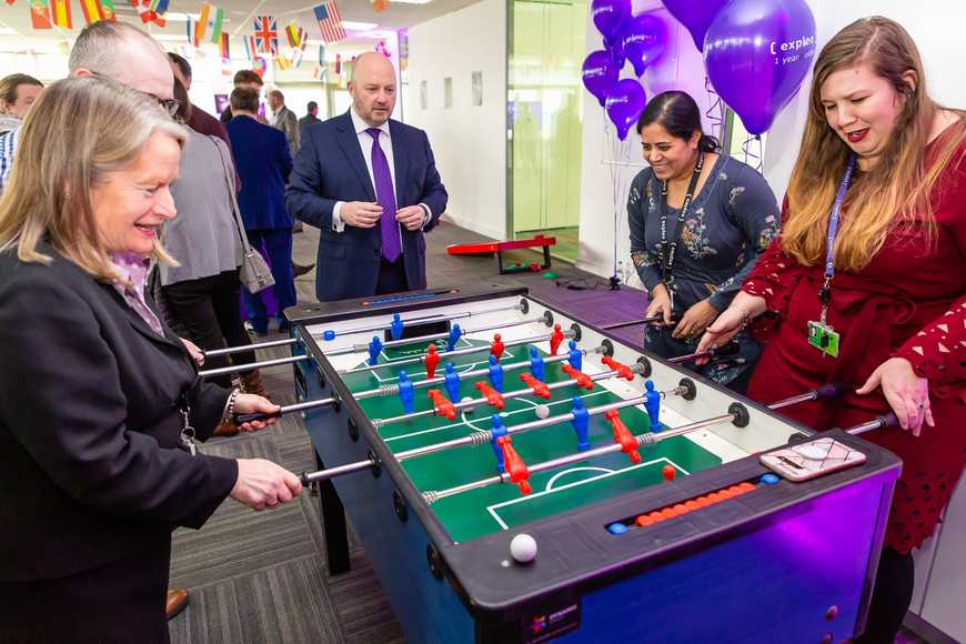 Corporate team building in Shannon with colleagues enjoying foosball during an office event