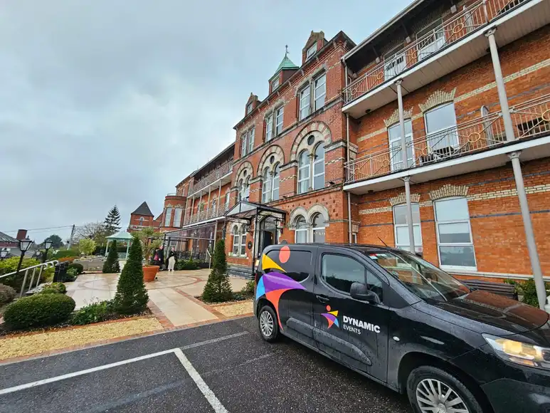 A Black Dynamic Events van outside a hotel in Cork city the hotel has a red brick wall outside | Team Training Cork