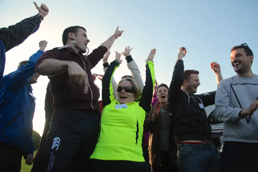Corporate team celebrating during a fun outdoor team building activity