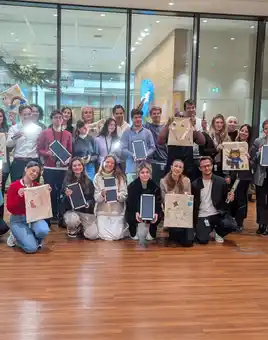 Corporate team holding decorated EcoBuddy bags and solar lights at CSR team building event