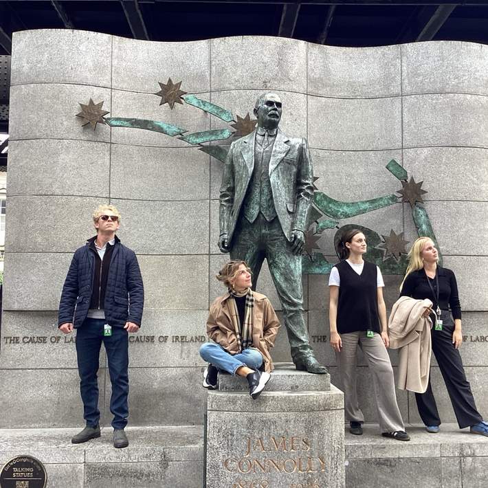 Graduate team posing at James Connolly Statue during onboarding treasure hunt in Dublin