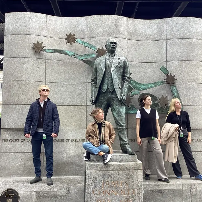 Graduate team posing at James Connolly Statue during onboarding treasure hunt in Dublin