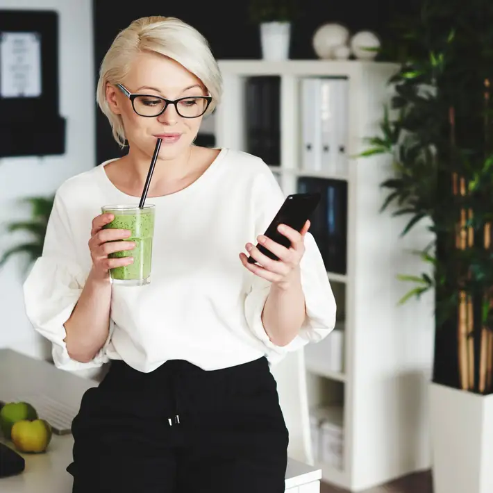 Woman drinking while on. ateam building call