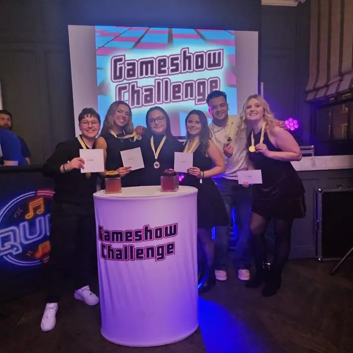 Winning team posing for a photo at their Corporate Christmas Party during the Gameshow