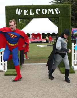 men dressed as superman and batman