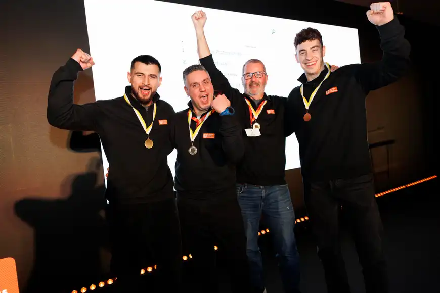 Corporate team celebrating with medals after completing a Venue Adventure digital treasure hunt in Ireland