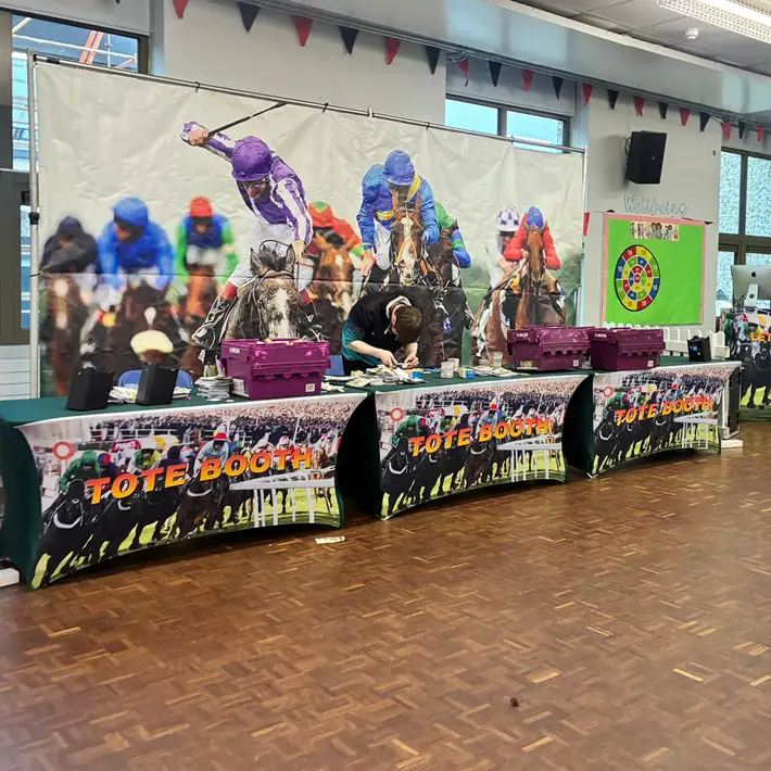 Corporate Race Night tote booth with bookmaker tables and horse racing backdrop