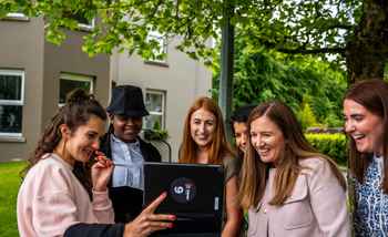 New hires working together outdoors during a digital treasure hunt as part of their onboarding programme in Dublin.
