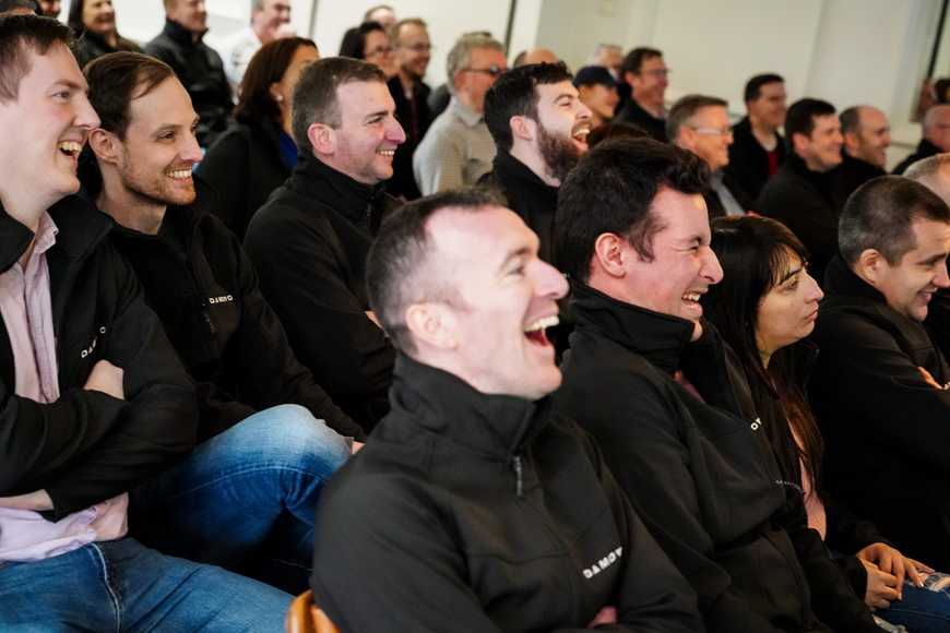 Indoor corporate team activities Ireland staff laughing during team event