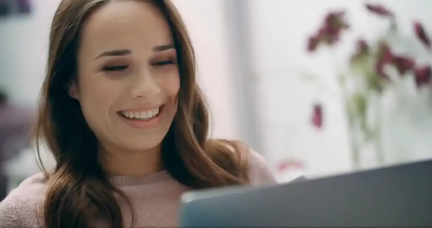 woman smiling at laptop screen