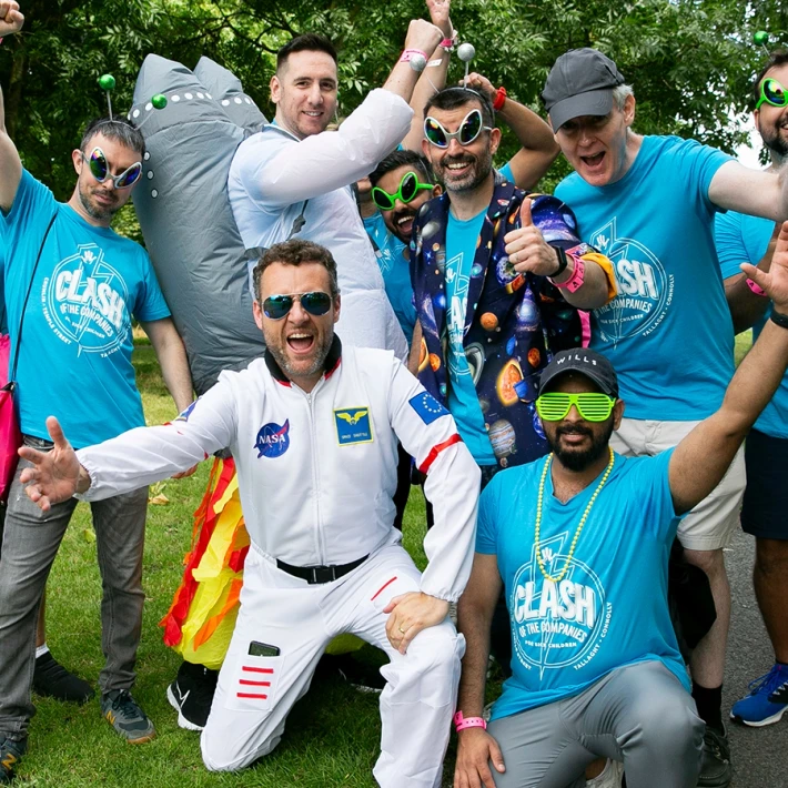Corporate team enjoying the Space Survival team building activity in Ireland, wearing fun space costumes and laughing together during an outdoor GPS treasure hunt organised by Dynamic Events.