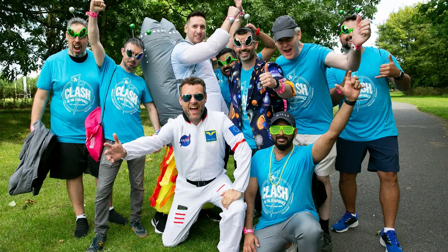 Corporate team enjoying the Space Survival team building activity in Ireland, wearing fun space costumes and laughing together during an outdoor GPS treasure hunt organised by Dynamic Events.