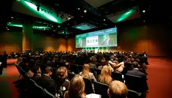 Corporate kick-off event with a large audience attending a keynote presentation in a modern conference venue in Ireland.
