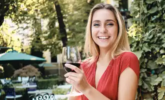 happy blond woman drinking wine