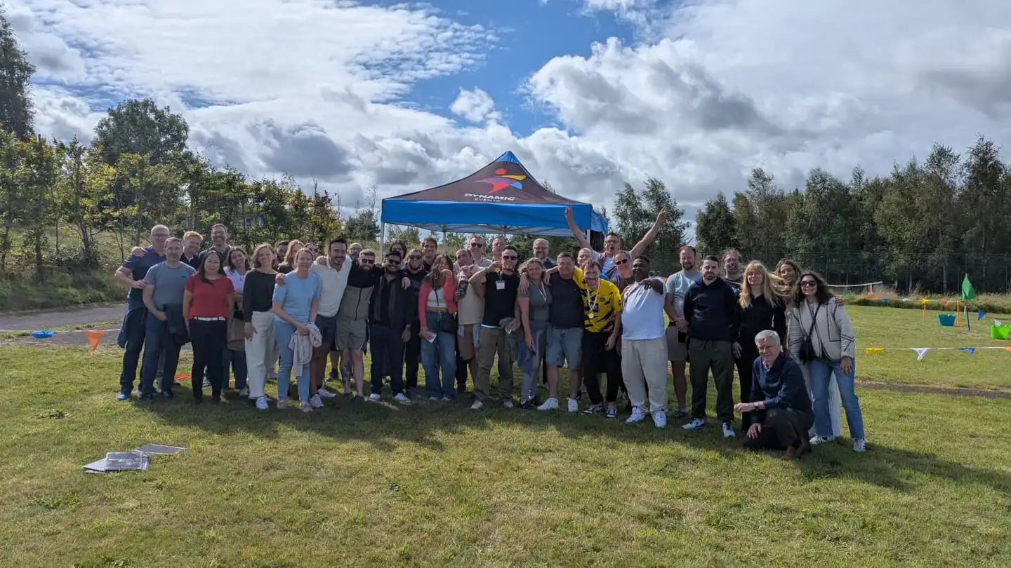 Corporate team building event in Northern Ireland with a large group outdoors under a Dynamic Events tent.
