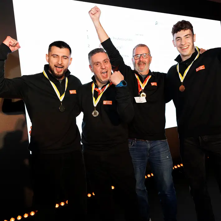 Remote team building treasure hunt winners celebrating with medals and cheering