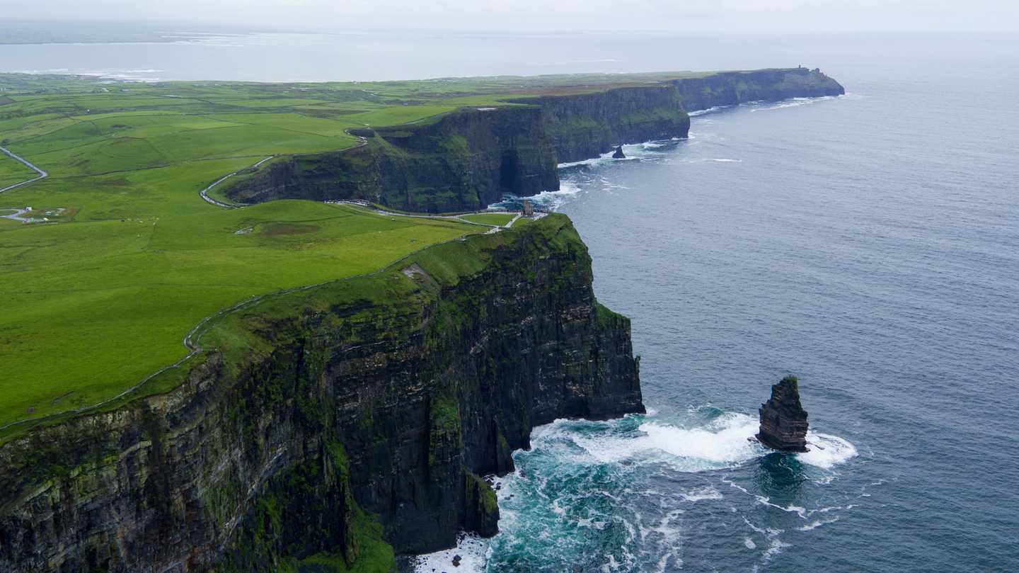 scenic view over green irish fields and mountains